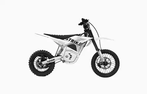 White electric dirt bike with knobby tires and a long front fork, labeled 'STRIK' on the body.