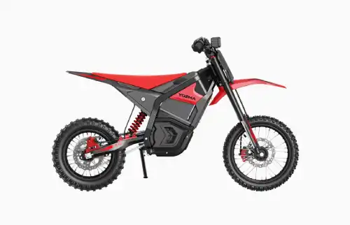 Electric dirt bike in side view with red body, black frame, knobby tires, and exposed suspension
